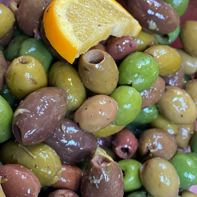 Close up of assorted olives and a lemon wedge